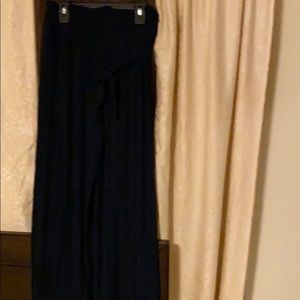 Pleated navy blue trousers.